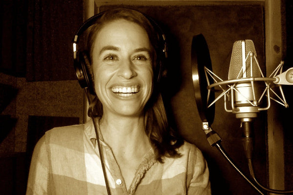 Professional voice actor recording in studio — real voices vs AI brand authenticity 2026