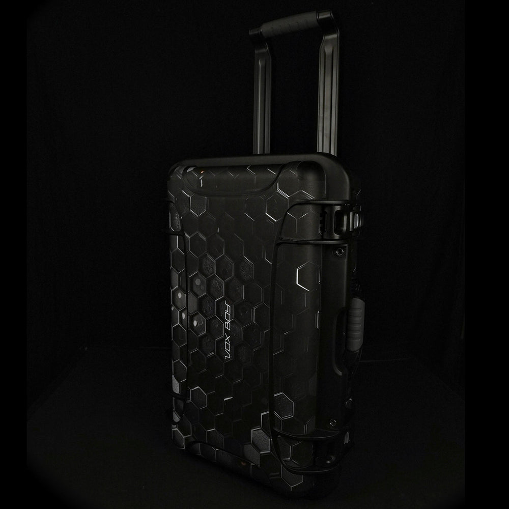 Vox Boy travel case standing upright with the telescoping handle extended, sized for carry-on