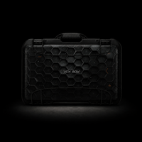 A black hard protective case with a honeycomb texture and the brand name 'VOX BOY' printed in the center, shown against a dark black background with dramatic lighting.